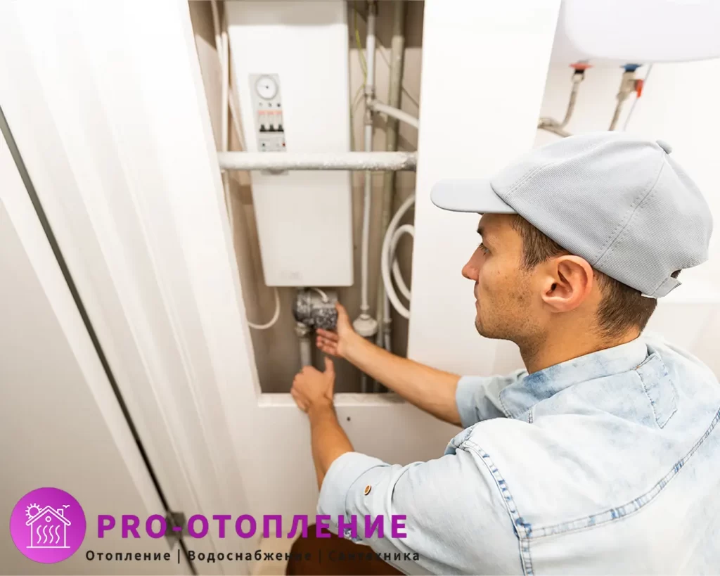 Мастер устанавливает компактный электрический котел в нишу